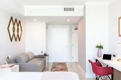 a living room with a couch and red chairs at MVR Suite-A Stay That Feels Like a Private Resort in Miami
