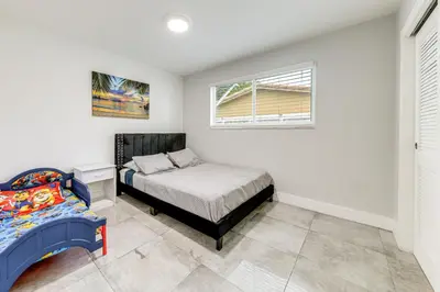 a bedroom with a bed and a window at Outdoor Oasis with Games Sleek Hollywood Home! in Hollywood