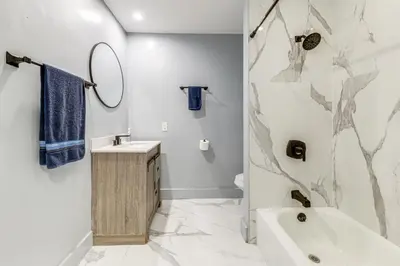 a bathroom with a tub and a sink and a mirror at Outdoor Oasis with Games Sleek Hollywood Home! in Hollywood