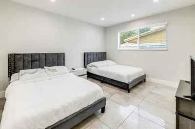 a bedroom with two beds and a television in it at Outdoor Oasis with Games Sleek Hollywood Home! in Hollywood