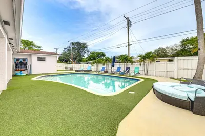 a swimming pool in a yard with chairs at Outdoor Oasis with Games Sleek Hollywood Home! in Hollywood