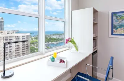 a room with windows and a white counter with a blue chair at MVR Not a normal suite-An Elevated Miami Stay in Miami