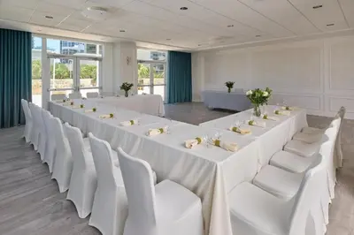 a large room with white tables and white chairs at MVR - This Miami Suite Is Built to Impress in Miami