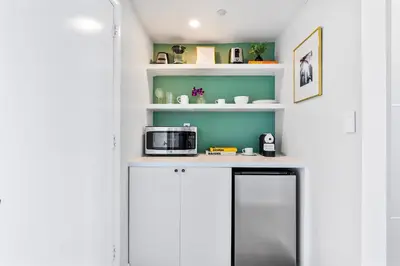 a kitchen with a counter with a microwave and shelves at MVR Designer Suite with Balcony and Miami-s Best Views in Miami