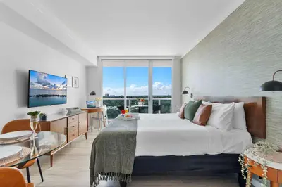 a bedroom with a large bed and a large window at MVR Designer Suite with Balcony and Miami-s Best Views in Miami
