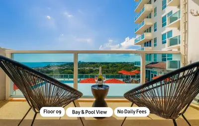 a pair of chairs on a balcony with a view of a building at MVR King Suite Room Bay View in Miami
