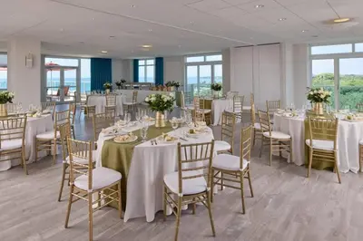 a banquet room with tables and chairs with white tablecloths at MVR King Suite Room Bay View in Miami