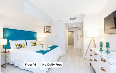 a white bedroom with a large bed and no daily fees at MVR Suite with Access to Miami-s Best Rooftop in Miami