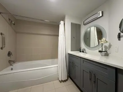 a bathroom with a tub and a sink and a mirror at MVR Biscayne-View Suite to Wake Up Inspired in Miami