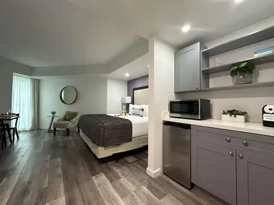 a bedroom with a bed and a kitchen with a microwave at MVR Biscayne-View Suite to Wake Up Inspired in Miami