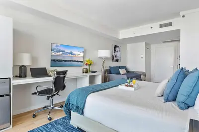 a bedroom with a bed and a desk and a chair at MVR Coconut Grove Suite You will want to Keep Secret in Miami