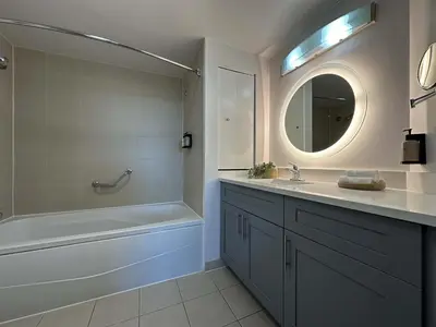 a bathroom with a tub and a sink and a mirror at MVR Suite Boutique Living with Big Luxury Energy in Miami