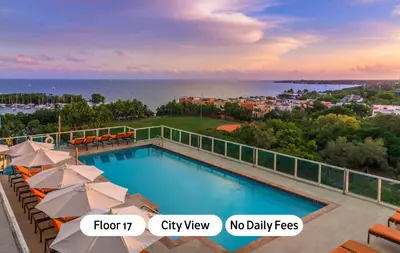 a swimming pool with umbrellas and a view of the ocean at MVR Suite Designed for Comfort and Connectivity in Miami