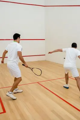 two men playing a game of tennis on a court at MVR Suite Designed for Comfort and Connectivity in Miami