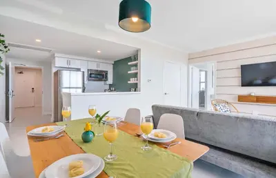 a dining room and living room with a table and chairs at MVR Biscayne Bay Views That Stun Daily in Miami