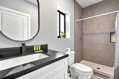 a bathroom with a sink and a toilet and a mirror at Comfy Studio W Beautiful Space! in Miami