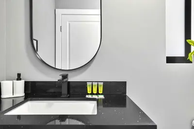 a bathroom with a sink and a mirror at Comfy Studio W Beautiful Space! in Miami