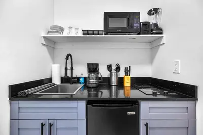 a kitchen counter with a sink and a microwave at Comfy Studio W Beautiful Space! in Miami