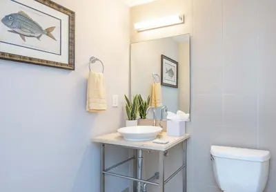 a bathroom with a sink and a toilet and a mirror at MVR Unforgettable Balconies Await You in Miami