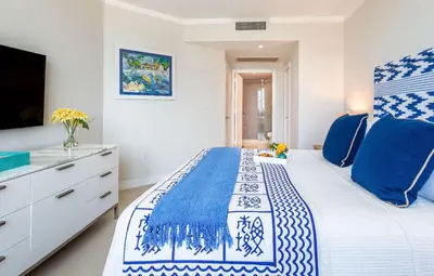 a bedroom with a blue and white bed and a tv at MVR Unforgettable Balconies Await You in Miami