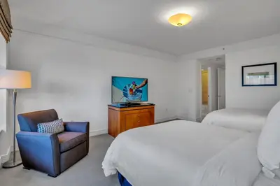 a bedroom with a bed and a chair at Four Seasons Miami Two Bedroom - 2Bath Ocean view Suite - Amazing views in Miami