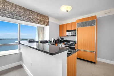 a kitchen with a counter and a large window at Four Seasons Miami Two Bedroom - 2Bath Ocean view Suite - Amazing views in Miami