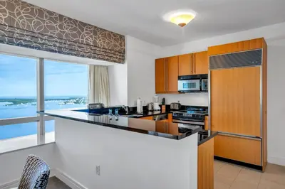a kitchen with a counter and a large window at Four Seasons Miami Two Bedroom - 2Bath Ocean view Suite - Amazing views in Miami