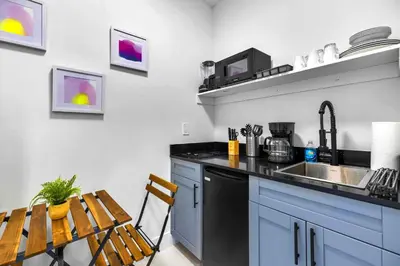 a kitchen with a counter and a sink and a table at Studio in Miami - Ideal for Couples & Travelers in Miami