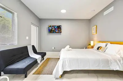 a bedroom with a large bed and a couch at Studio in Miami - Ideal for Couples & Travelers in Miami