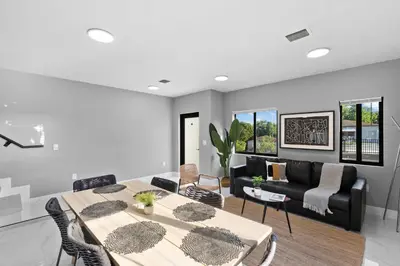 a living room with a table and chairs and a couch at Amazing Townhouse w Free Parking in Miami