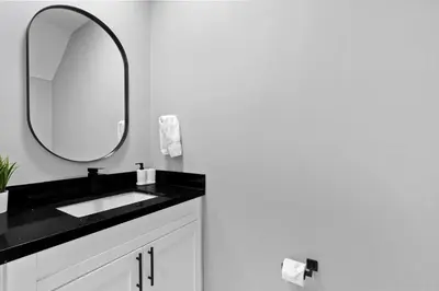 a bathroom with a black sink and a mirror at Amazing Townhouse w Free Parking in Miami