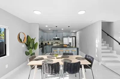 a kitchen and dining room with a table and chairs at Amazing Townhouse w Free Parking in Miami