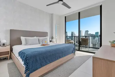 a bedroom with a bed with a blue blanket on it at MVR Skyline Luxury in Downtown Miami in Miami