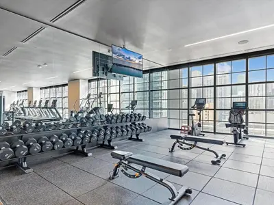 a gym with cardio equipment and a flat screen tv at MVR Skyline Luxury in Downtown Miami in Miami