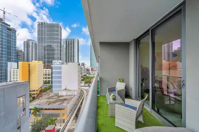 a balcony with chairs and a view of a city at Best Location 2 bedrooms 2 bathrooms in Miami