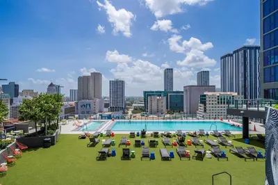 a large pool with lounge chairs and a city skyline at Best Location 2 bedrooms 2 bathrooms in Miami
