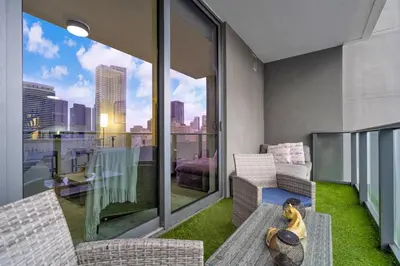 a living room with a dog sitting on a bench on a balcony at Best Location 2 bedrooms 2 bathrooms in Miami