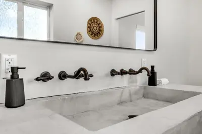 a bathroom with a sink and a mirror at 4BR Biscayne River Home- Pool & Pickleball Fun home in Miami
