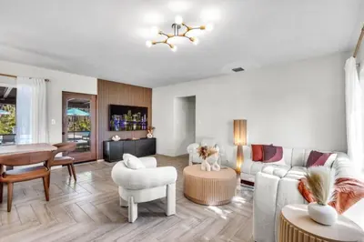 a living room with a couch and a table at 4BR Biscayne River Home- Pool & Pickleball Fun home in Miami