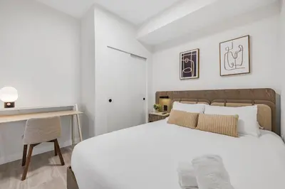 a bedroom with a white bed and a desk at Luxury Miami Beach Condo At 72 Park in Miami Beach