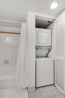 a bathroom with a shower and a toilet and a tub at Stylish 1BR Brickell Retreat Walk to Everything in Miami