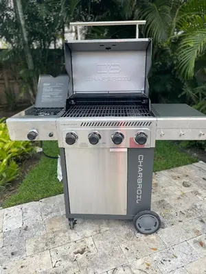 a barbecue grill with a laptop on top of it at Chic Fort Lauderdale Getaway w/Private Heated Pool in Fort Lauderdale