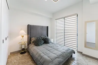 a bedroom with a large bed with a large window at Lux Design Apartment near beach in Fort Lauderdale