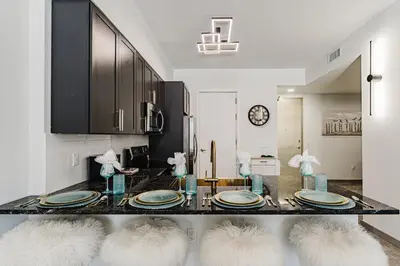 a dining room with a table with plates on it at Lux Design Apartment near beach in Fort Lauderdale