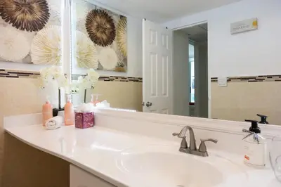 a bathroom with a sink and a mirror at Beachfront 2 BR Apt Full Kitchen - No Resort Fee in Hollywood