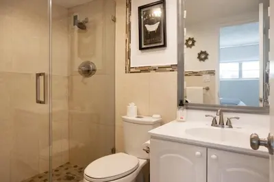 a bathroom with a toilet and a sink and a shower at Beachfront 2 BR Apt Full Kitchen - No Resort Fee in Hollywood