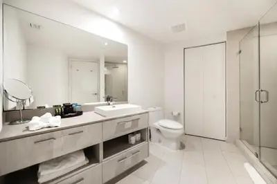 a white bathroom with a sink and a toilet at Beachfront Luxury Condo in Hollywood in Hollywood