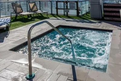 a hot tub with a hand rail in a building at Beachfront Luxury Condo in Hollywood in Hollywood