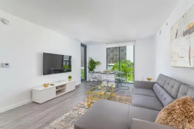a living room with a couch and a tv at Spacious and bright in the heart of Brickell in Miami