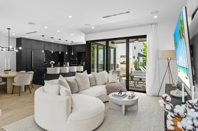 a living room with a white couch and a table at Modern Zen Oasis in Design District Sleeps 16 in Miami